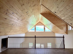 Upstairs view of custom knotty pine vaulted ceiling.