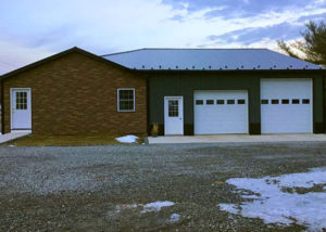 Garage with stone facade and new metal roof.