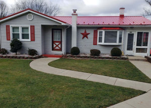 Ranch house with new red metal roof.